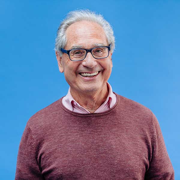 Happy senior businessman with glasses and smart casual